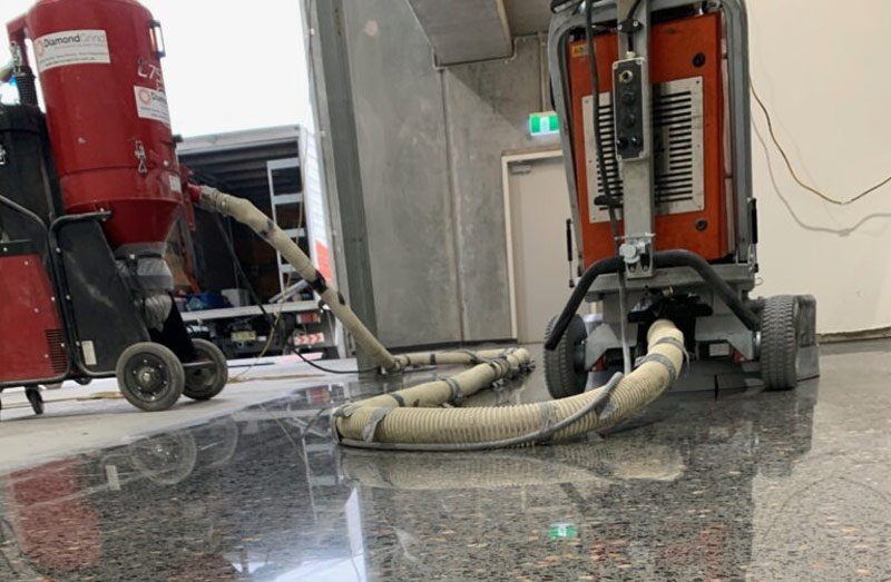 Precision diamond grinding of a concrete slab to prepare the surface for a professional grind and seal application.